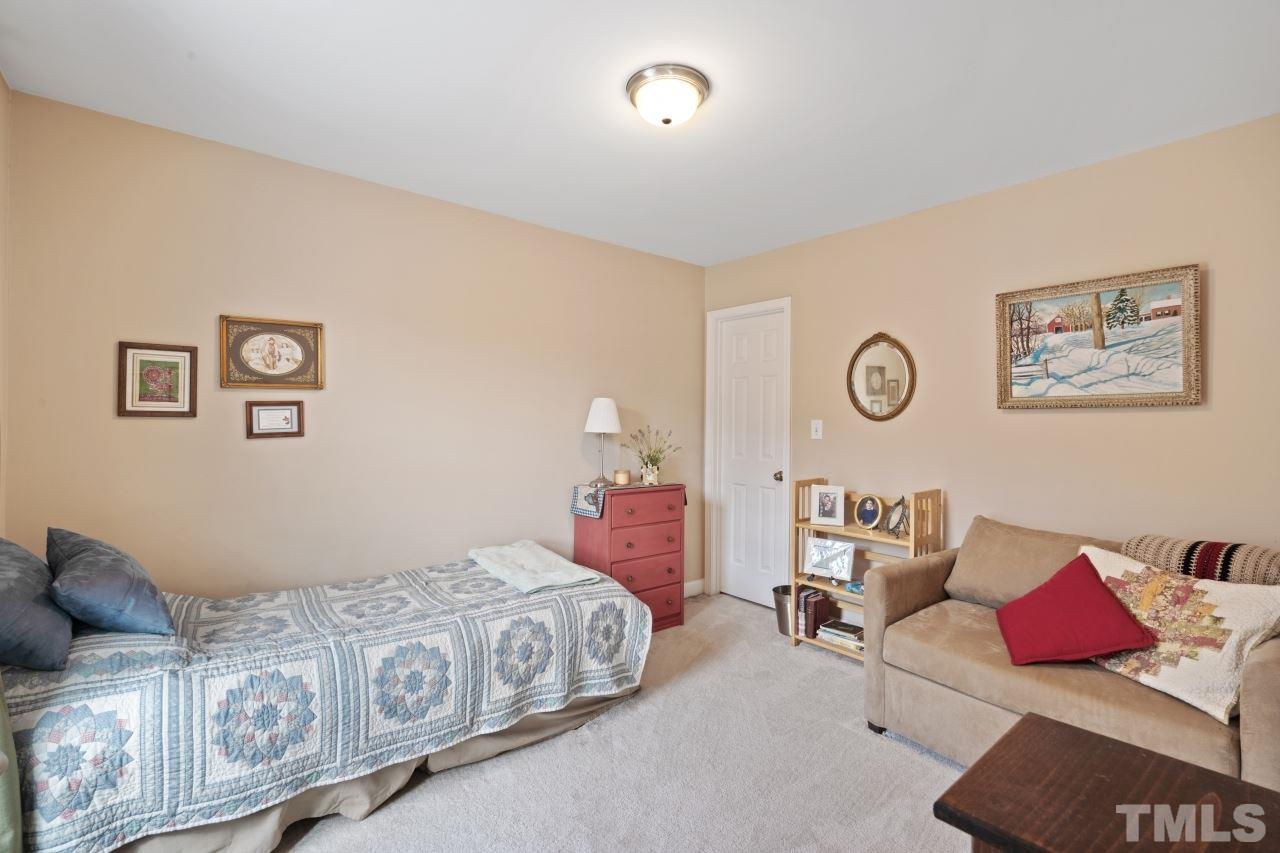 2307 King Malcolm Lane Zebulon, NC 27597 - Photo 15 of 30 a bedroom with furniture and a bed