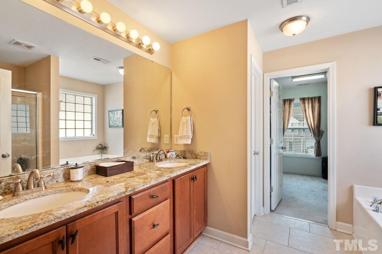 2307 King Malcolm Lane Zebulon, NC 27597 - Photo 23 of 30 a bathroom with a granite countertop sink mirror and