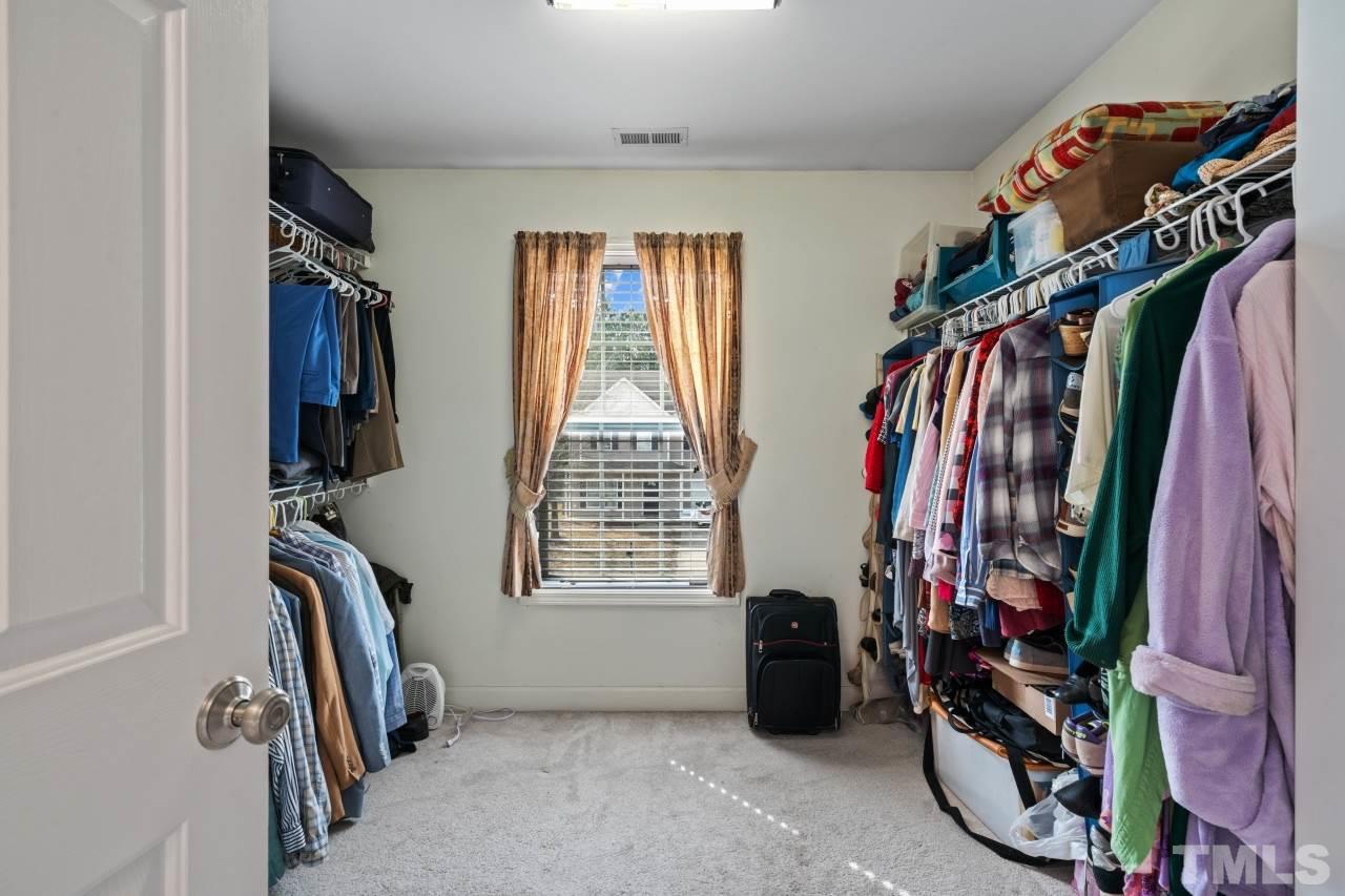 2307 King Malcolm Lane Zebulon, NC 27597 - Photo 24 of 30 a view of walk in closet with clothes and shoes