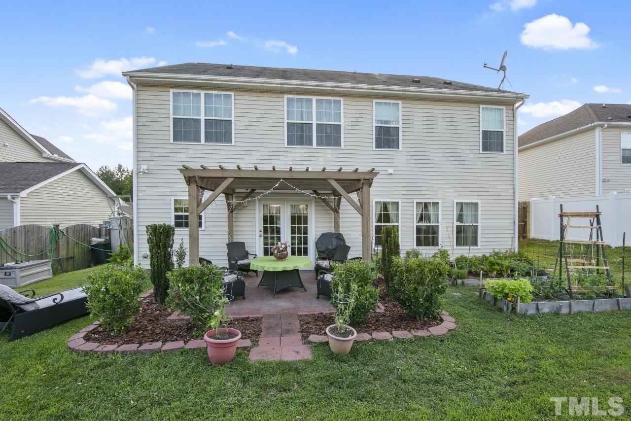2307 King Malcolm Lane Zebulon, NC 27597 - Photo 29 of 30 a front view of a house with a garden and plants
