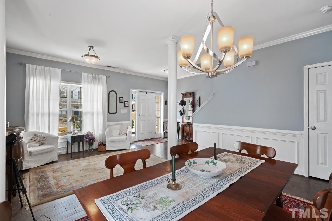 2307 King Malcolm Lane Zebulon, NC 27597 - Photo 5 of 30 a living room with furniture a rug and a chandelier