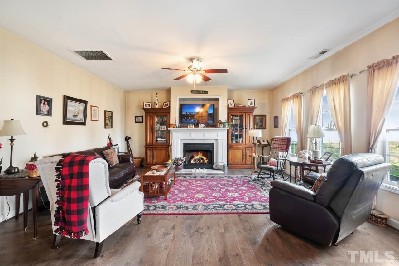 2307 King Malcolm Lane Zebulon, NC 27597 - Photo 7 of 30 a living room with furniture fireplace and window