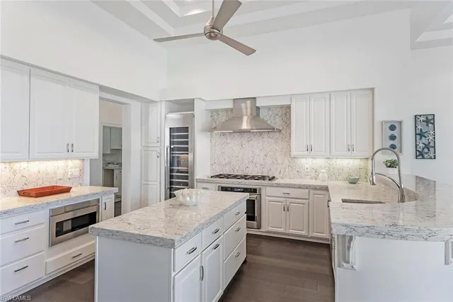 a kitchen with stainless steel appliances granite countertop a stove and a sink