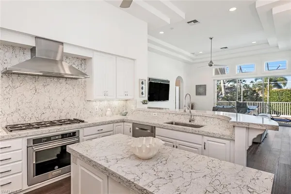 a kitchen with stainless steel appliances a sink stove and cabinets