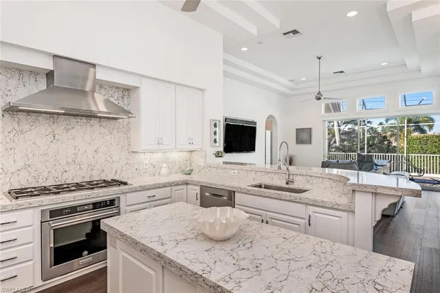 a kitchen with stainless steel appliances a sink stove and cabinets