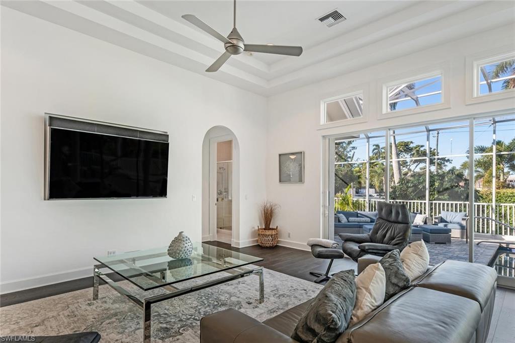 2540 Half Moon Walk Naples, FL 34102 - Photo 19 of 44 a living room with furniture a flat screen tv and a window