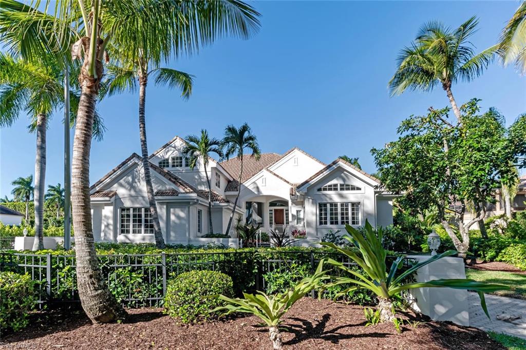 2540 Half Moon Walk Naples, FL 34102 - Photo 2 of 44 a front view of a house with a garden