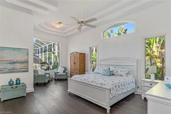 a bedroom with a bed couch and a window