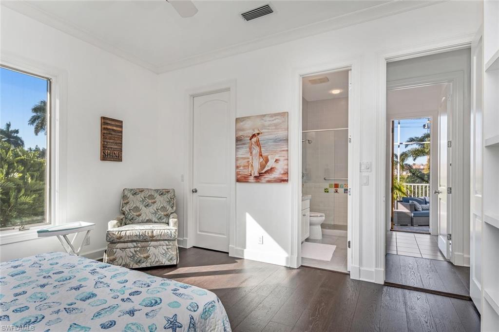 2540 Half Moon Walk Naples, FL 34102 - Photo 28 of 44 a bedroom with a bed and wooden floor