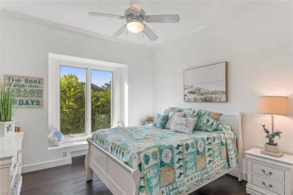 a bedroom with a large bed and a window
