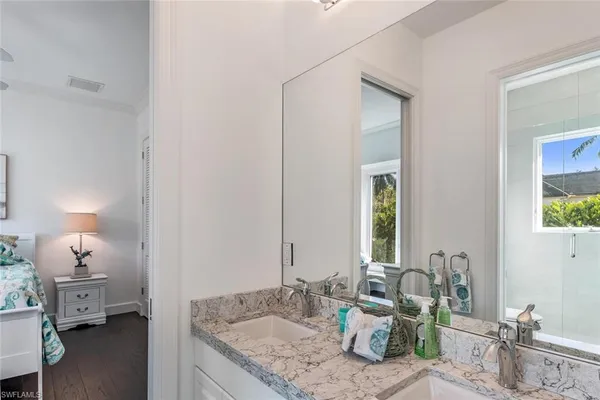 a bathroom with a granite countertop sink and a mirror