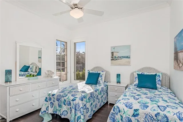 a bedroom with two beds and a dresser