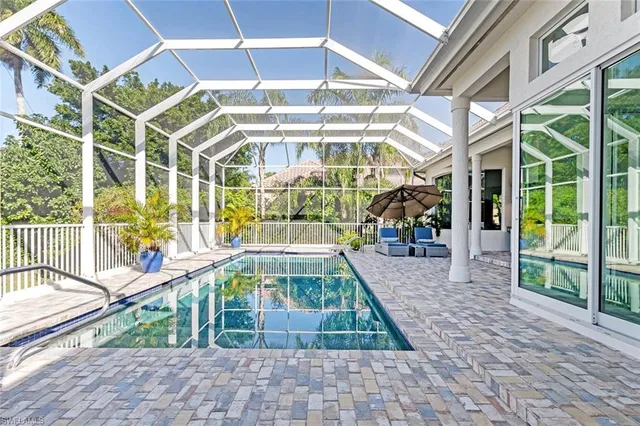 a view of a swimming pool with outdoor seating