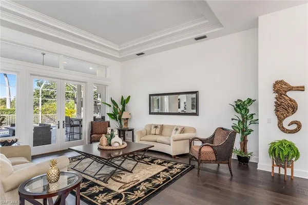 a living room with furniture potted plant and a window