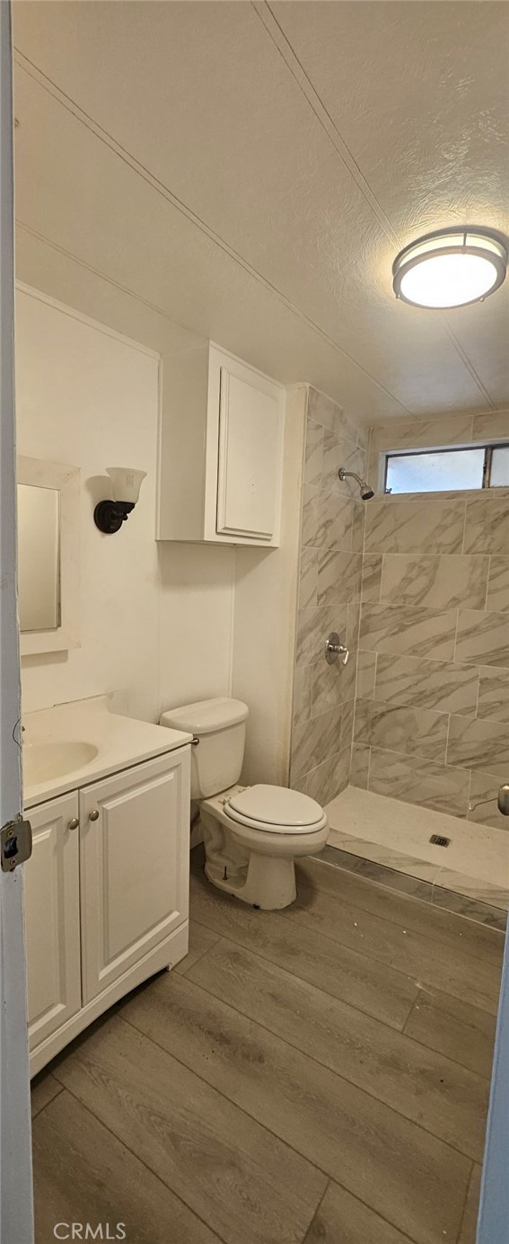 995 Pomona Road, Unit 33 Corona, CA 92882 - Photo 6 of 8 a bathroom with a sink a toilet and a mirror