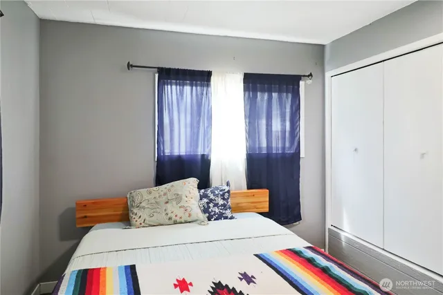 a bedroom with a bed and a closet