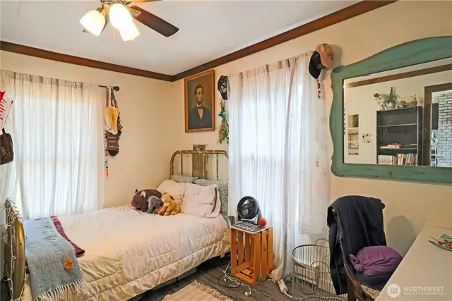 a bedroom with a bed couch and a window