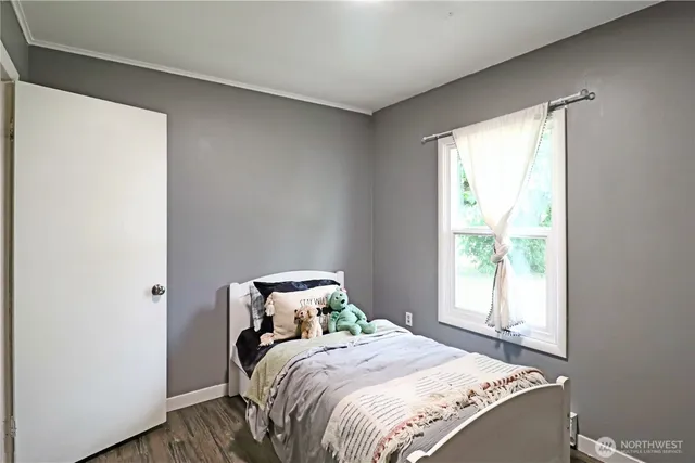 a bed sitting in a bedroom next to a window