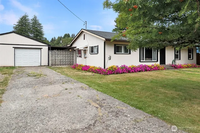 a front view of a house with a white fence