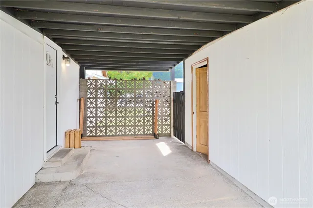 a view of empty room with floor to ceiling window and stairs