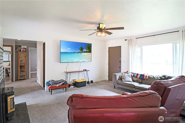 a bedroom with a bed a couch and a flat screen tv