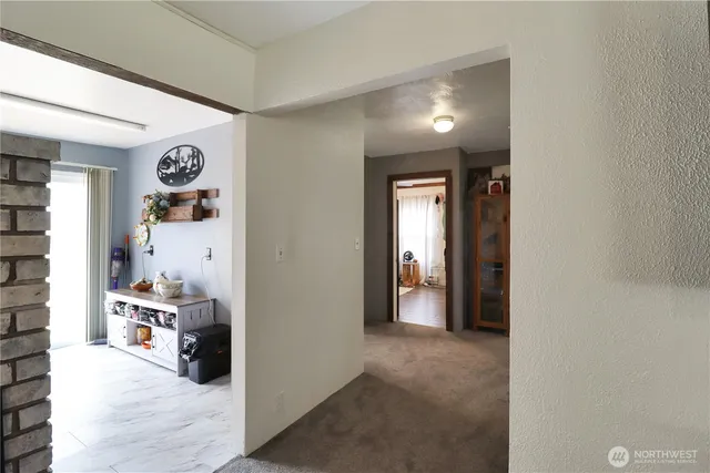 a view of a hallway with bathroom and front door