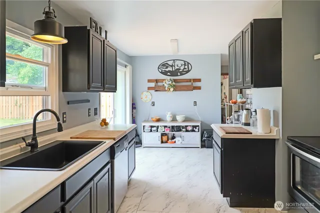 a kitchen with kitchen island a sink stove and refrigerator