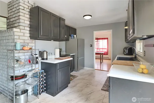 a kitchen with a sink stove and wooden cabinets