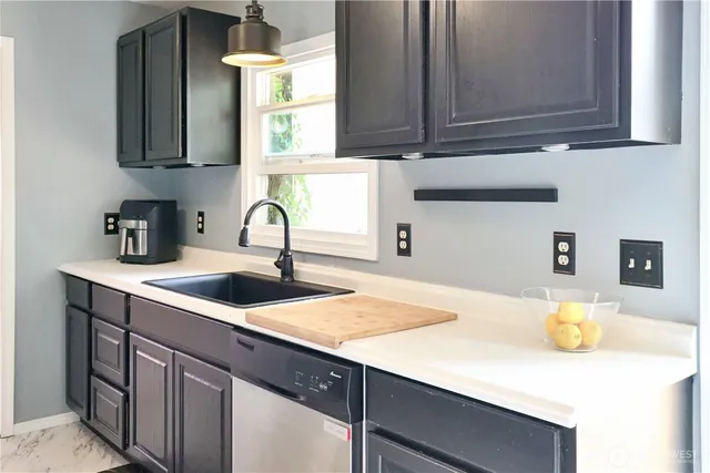 a kitchen with sink and a window