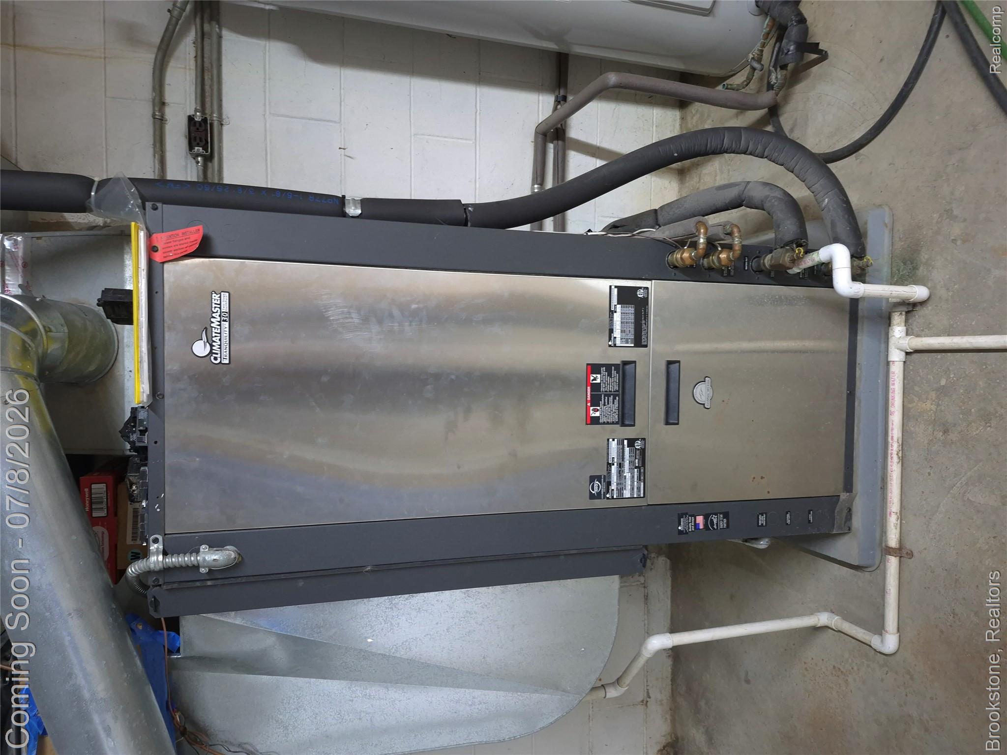 4140 South Henderson Road Davison, MI 48423 - Photo 80 of 98 ClimateMaster geothermal heat pump system with stainless steel paneling, integrated ductwork, and exposed PVC piping