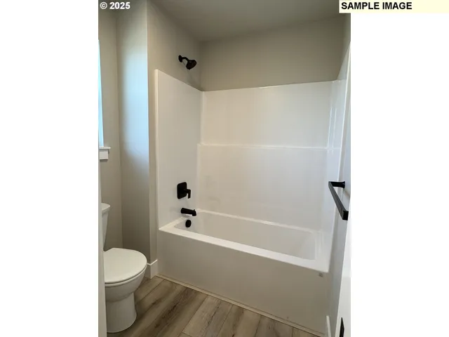 a bathroom with a toilet and a bathtub