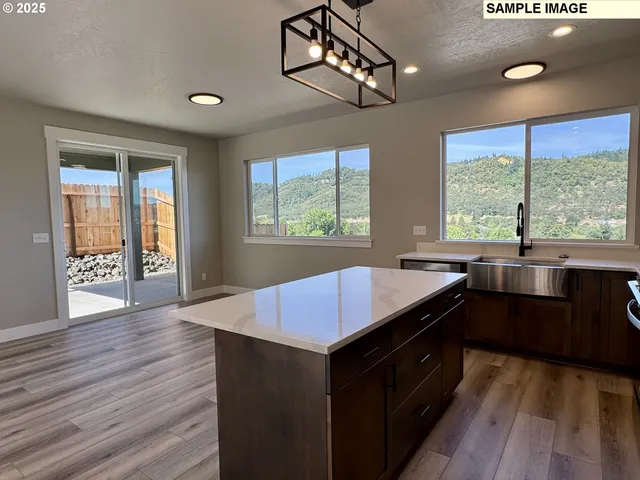 a kitchen with a stove a sink and wooden cabinets