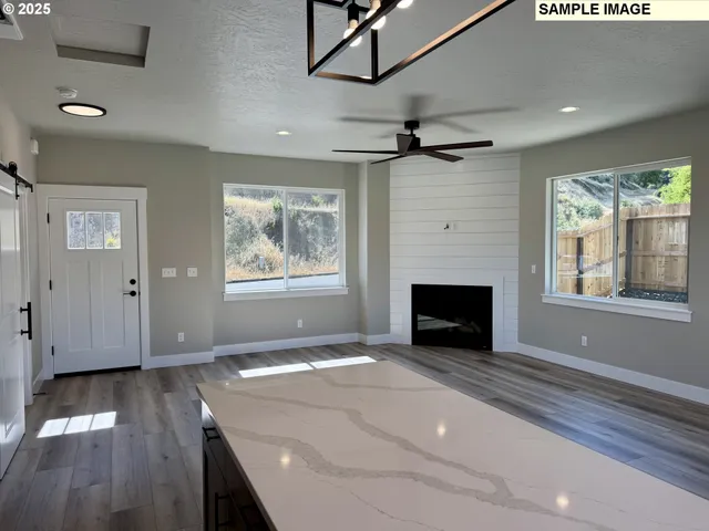 a view of livingroom with window fireplace and hardwood floor