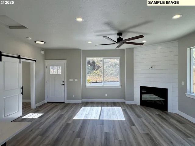wooden floor in an empty room with a fireplace
