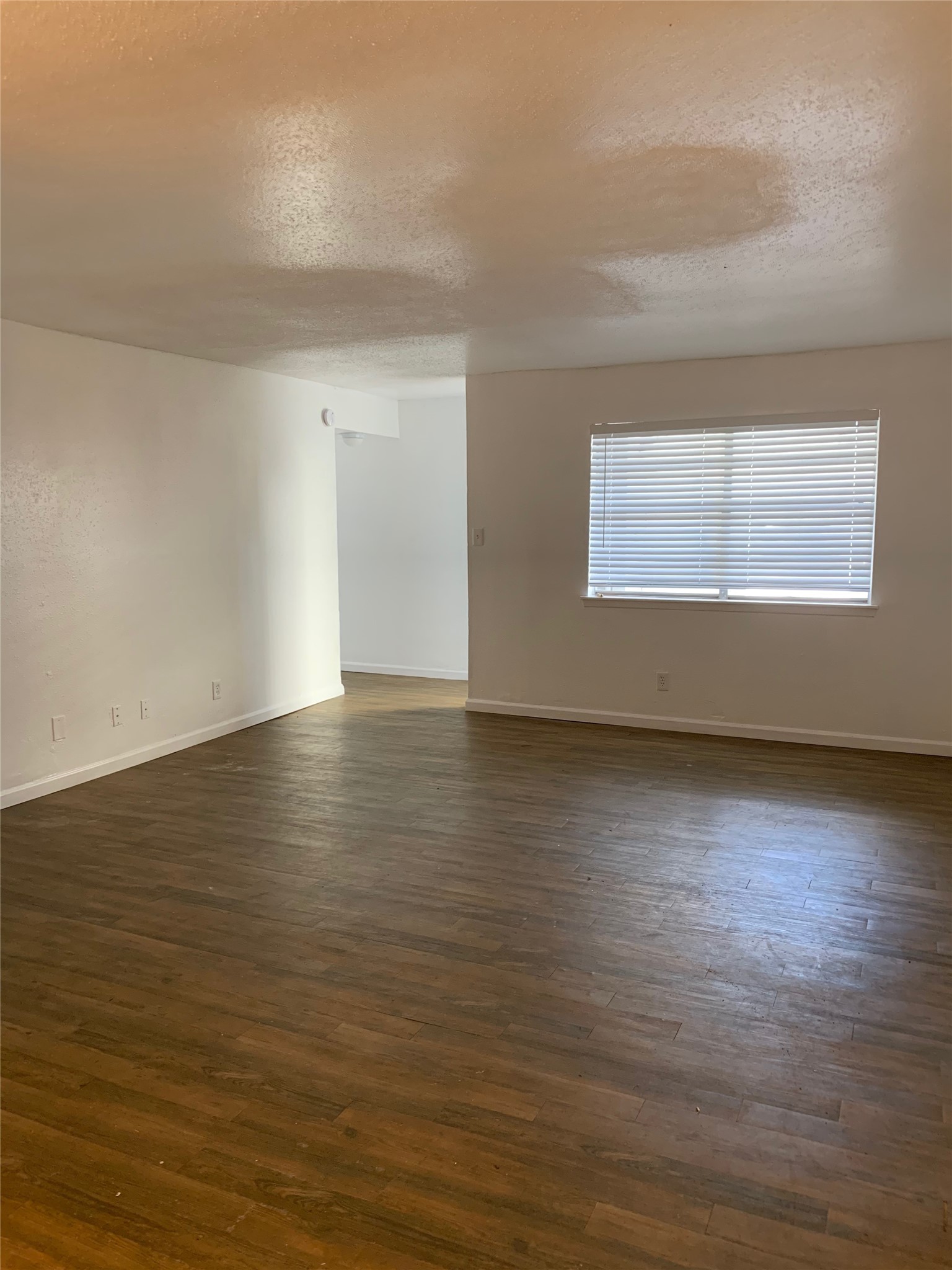 6200 West Tidwell Road, Unit 707 Houston, TX 77092 - Photo 5 of 10 an empty room with wooden floor and windows