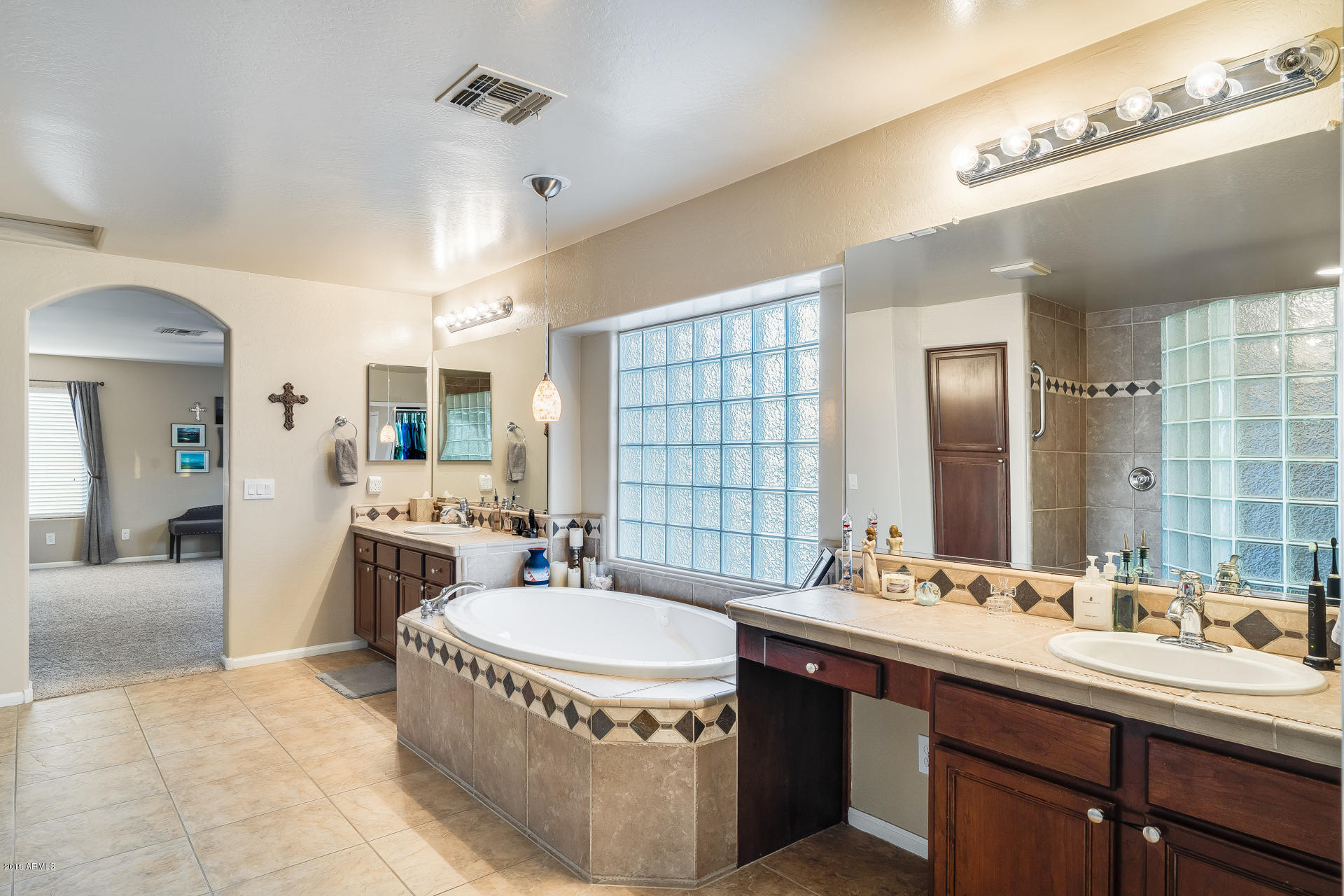2028 West Caleb Road Phoenix, AZ 85085 - Photo 42 of 57 a bathroom with a sink double vanity granite tub and a mirror