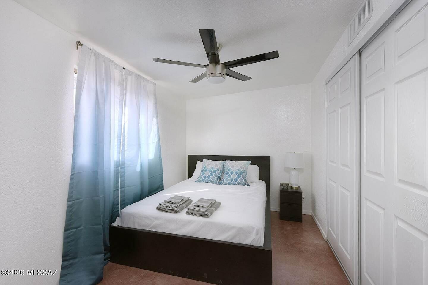 4415 North Swan Road Tucson, AZ 85718 - Photo 8 of 33 a bedroom with a bed and a window