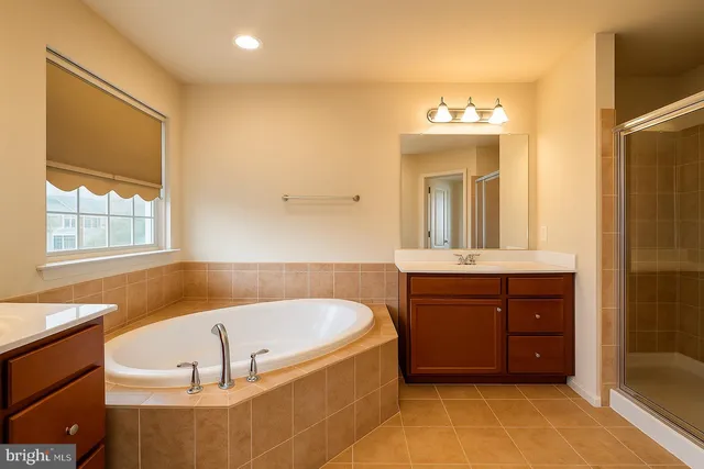 a bathroom with a tub sink and mirror