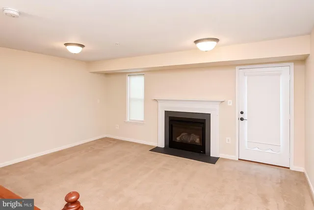 a view of an empty room with a fireplace