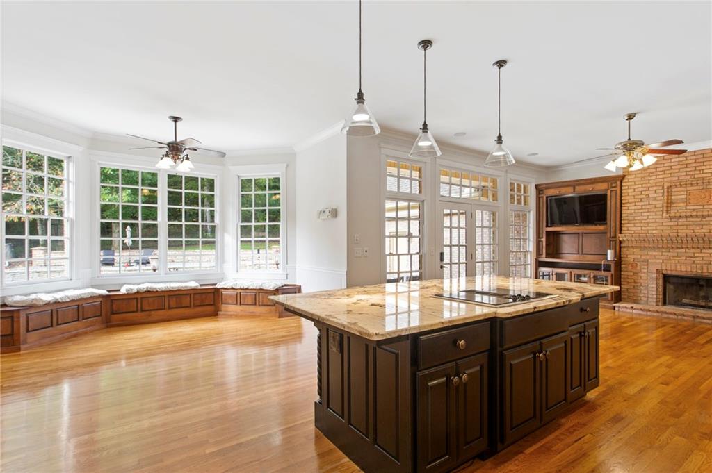 2115 Euharlee Road Taylorsville, GA 30178 - Photo 23 of 66 a kitchen with kitchen island granite countertop a sink and a wooden floor