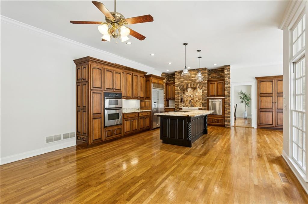 2115 Euharlee Road Taylorsville, GA 30178 - Photo 27 of 66 a large kitchen with stainless steel appliances a large counter top a stove and a refrigerator