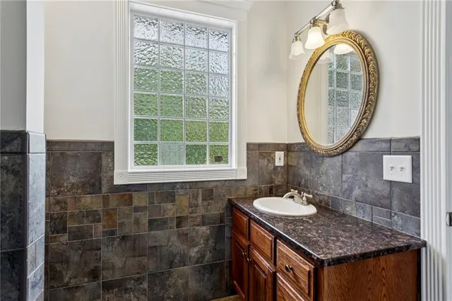 a kitchen with stainless steel appliances kitchen island granite countertop a stove and a sink