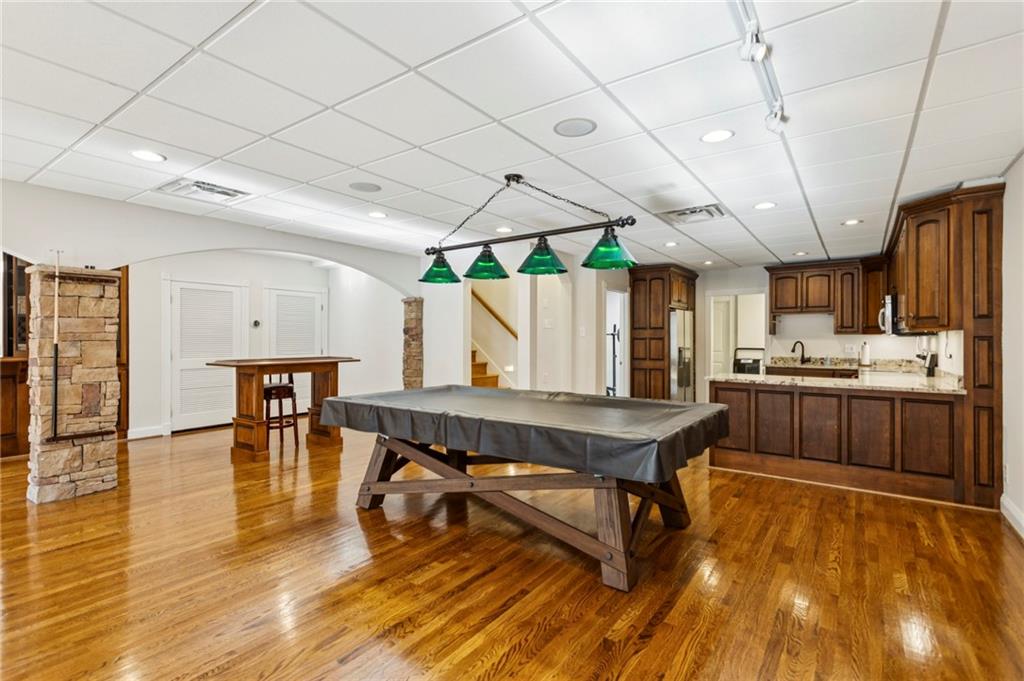 2115 Euharlee Road Taylorsville, GA 30178 - Photo 48 of 66 a room with stainless steel appliances kitchen island granite countertop a table chairs and a wooden floors