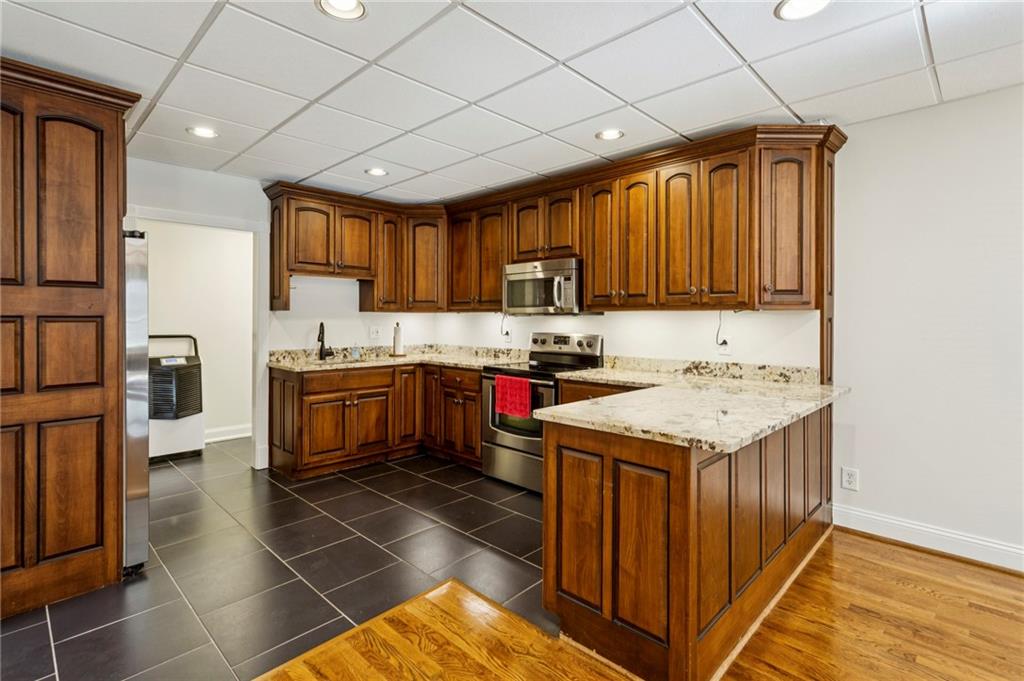 2115 Euharlee Road Taylorsville, GA 30178 - Photo 51 of 66 a kitchen with granite countertop a sink a counter top space and cabinets
