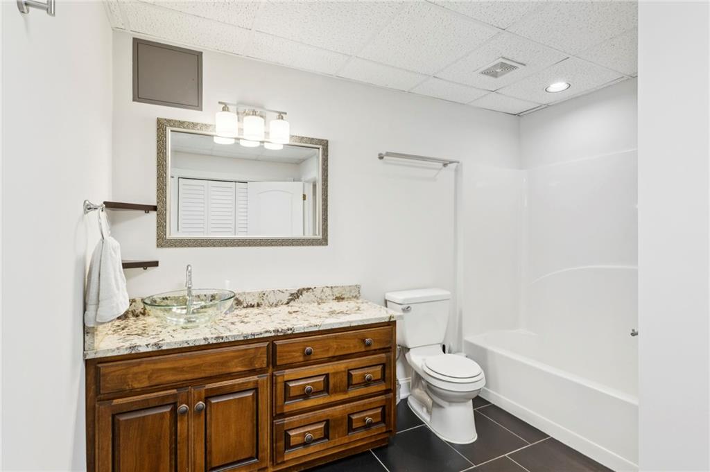 2115 Euharlee Road Taylorsville, GA 30178 - Photo 55 of 66 a bathroom with a granite countertop sink toilet a large mirror and shower