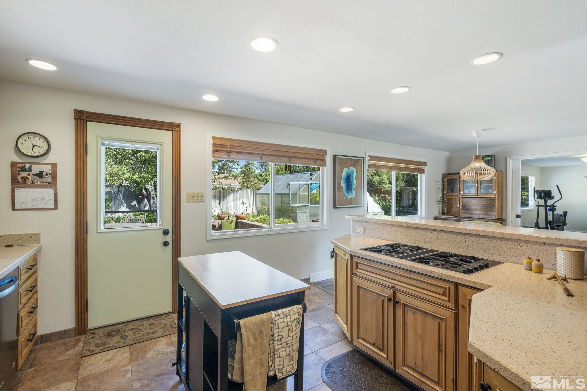 1000 Sumac Street Reno, NV 89509 - Photo 13 of 40 a kitchen with stainless steel appliances granite countertop a stove a sink dishwasher and a refrigerator with wooden floor