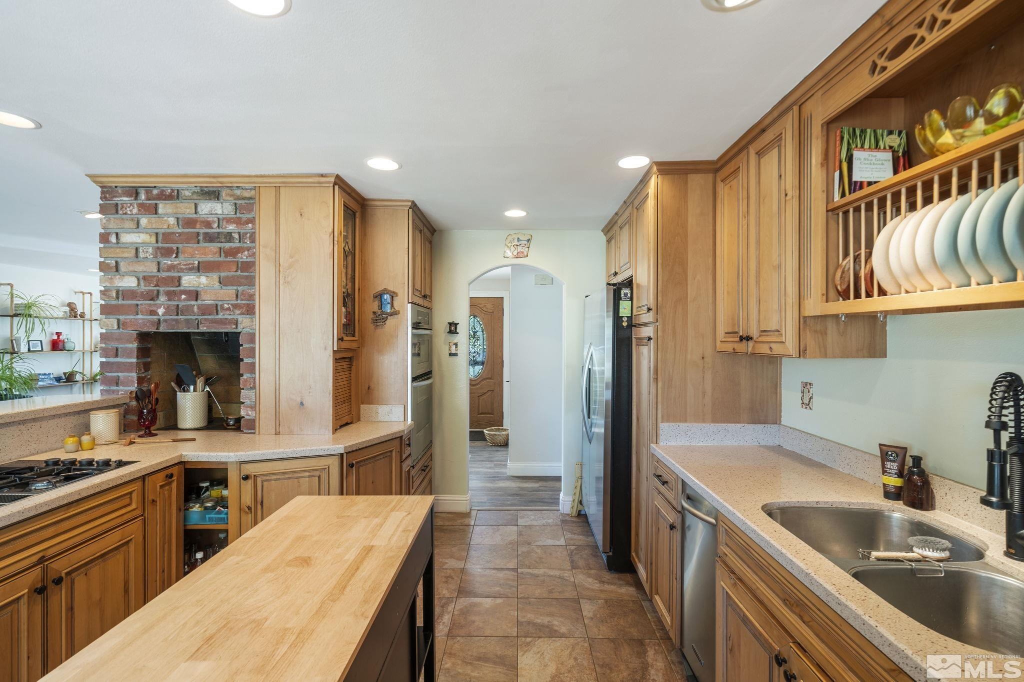 1000 Sumac Street Reno, NV 89509 - Photo 14 of 40 a kitchen with stainless steel appliances granite countertop a sink stove and refrigerator