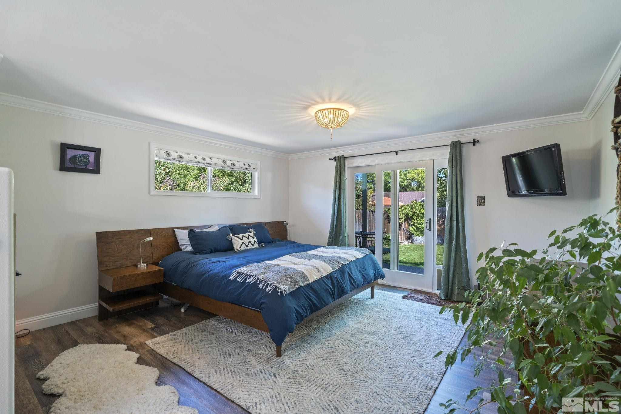 1000 Sumac Street Reno, NV 89509 - Photo 17 of 40 a bedroom with a bed a flat screen tv and potted plant