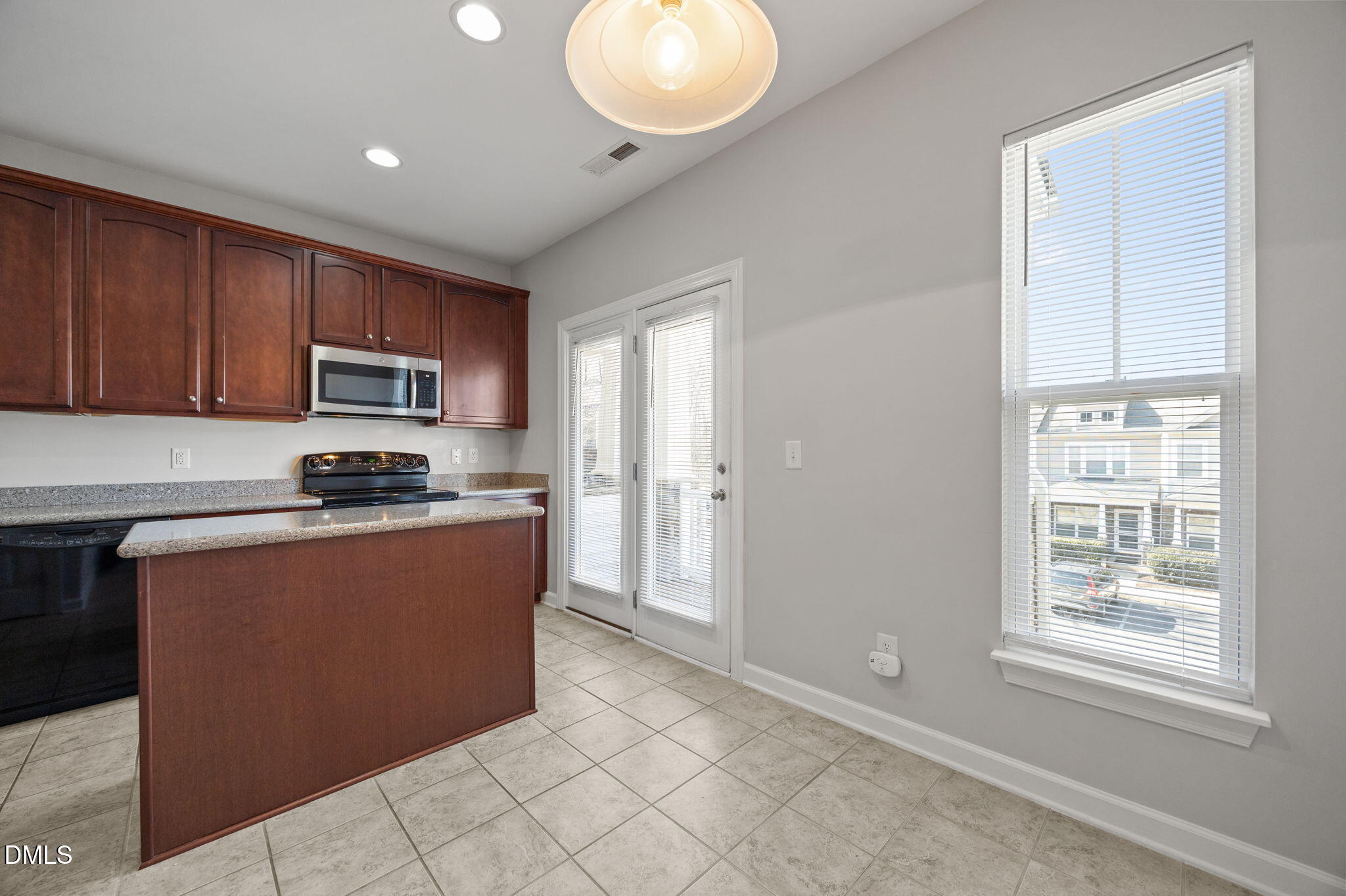 8006 Goldenrain Way Raleigh, NC 27612 - Photo 12 of 40 a kitchen with stainless steel appliances granite countertop a refrigerator sink and microwave