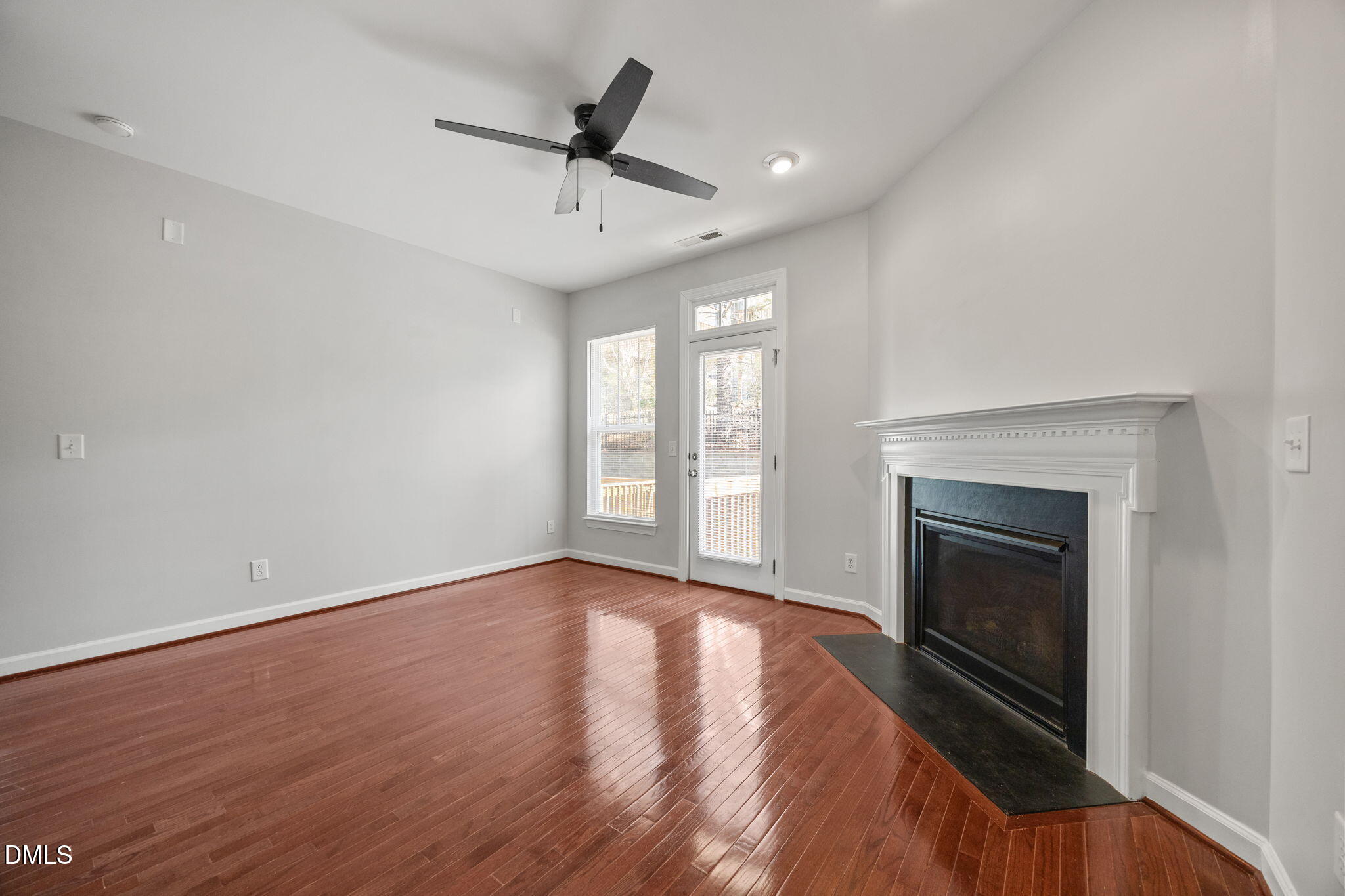 8006 Goldenrain Way Raleigh, NC 27612 - Photo 18 of 40 a view of an empty room with a fireplace and a window
